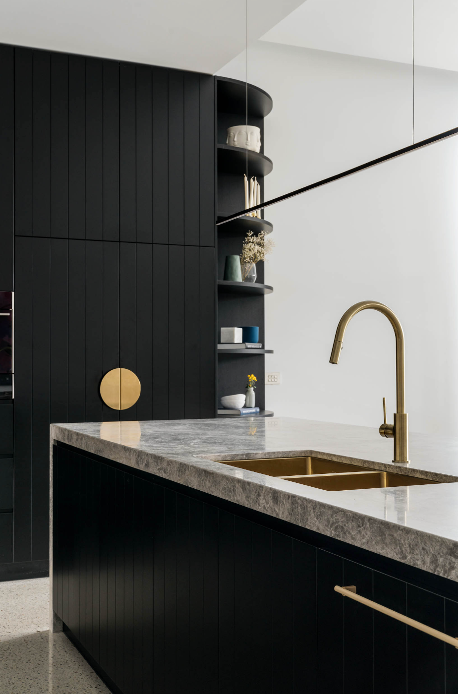 Brass tapware and sink in black kitchen