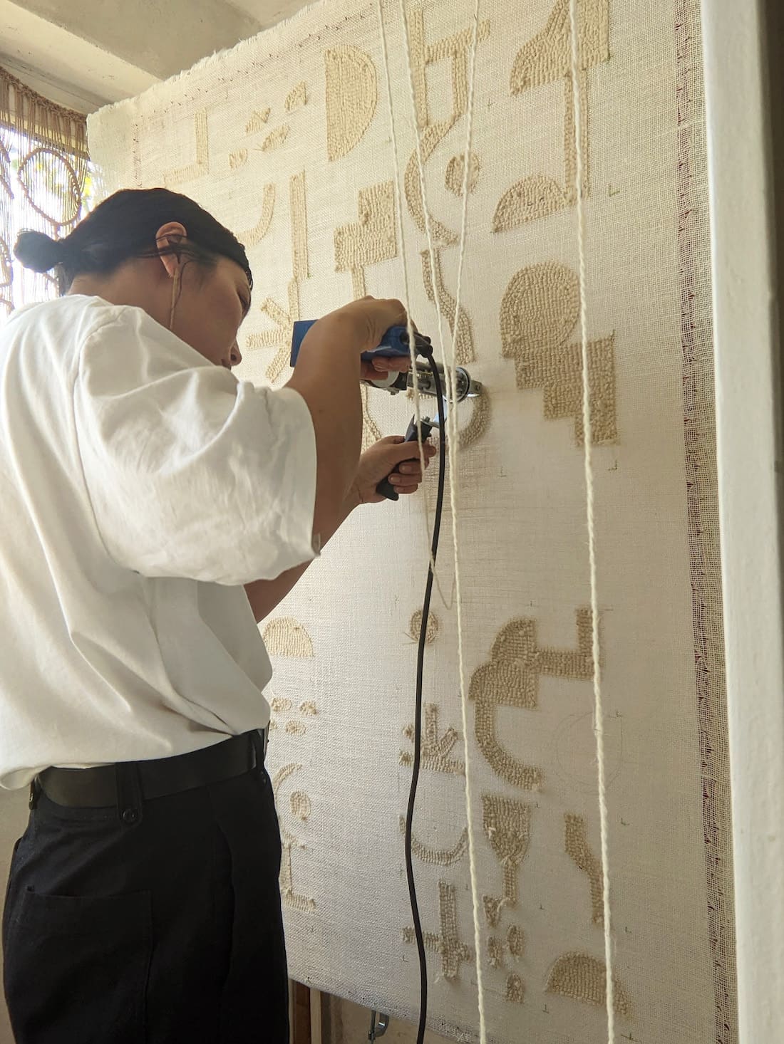 Ayako Matsuo using tufing gun to make craft