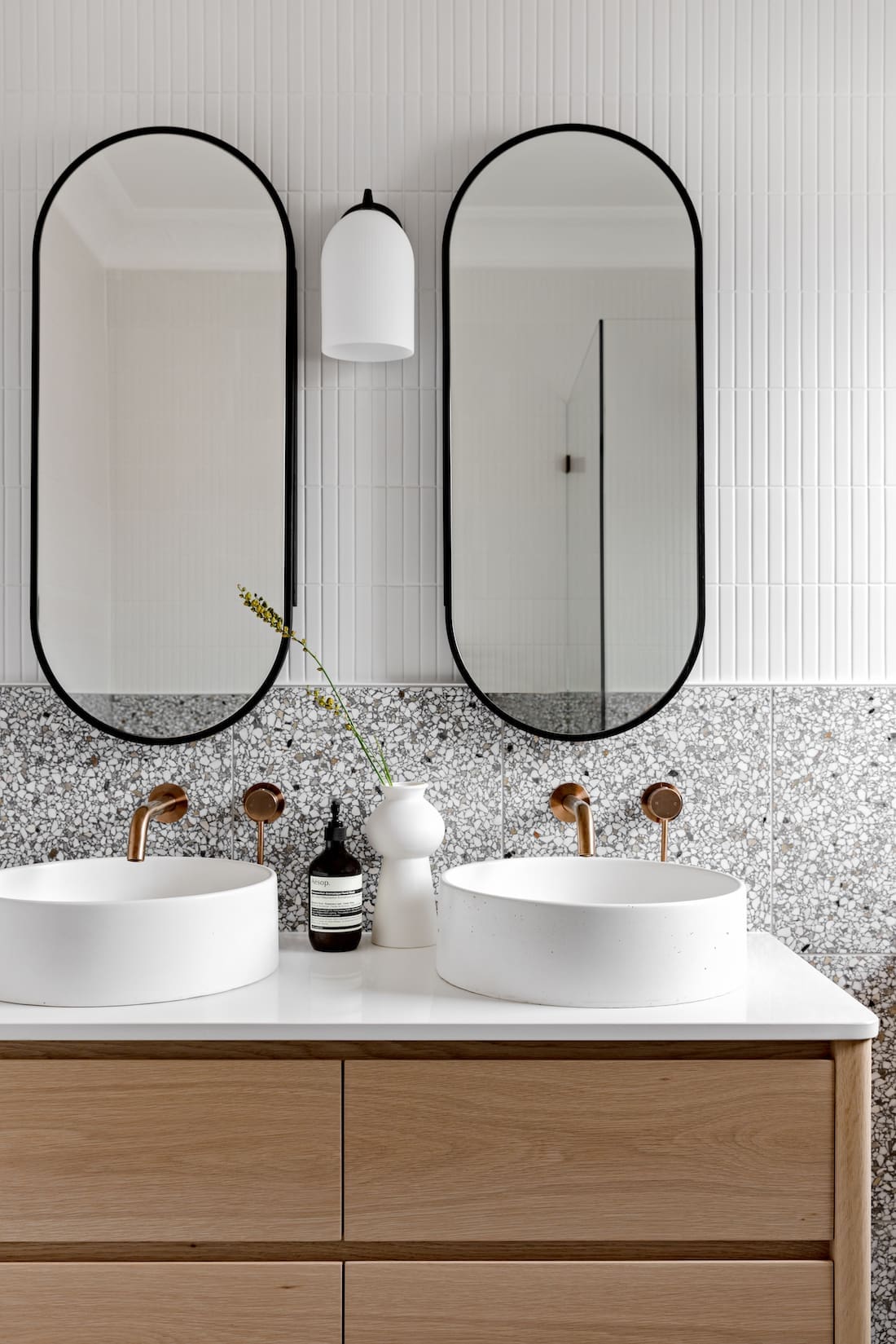 Double white round vanity with oval mirrors