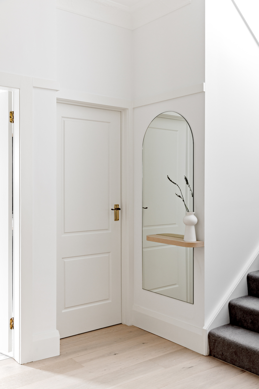 White hallway with full length mirror