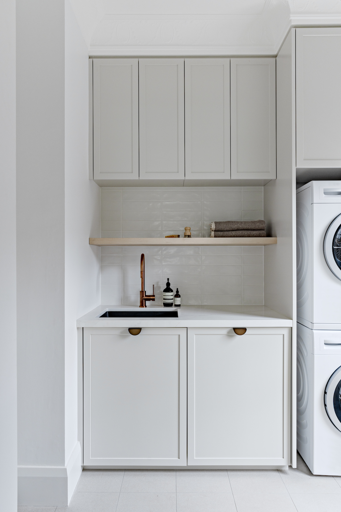 Stacked washer and dryer in modern laundry