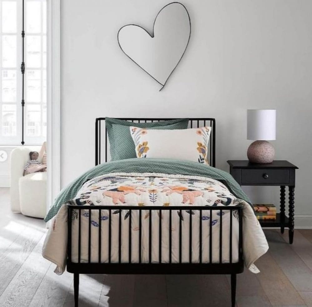 Black bedframe with love heart wall hanging