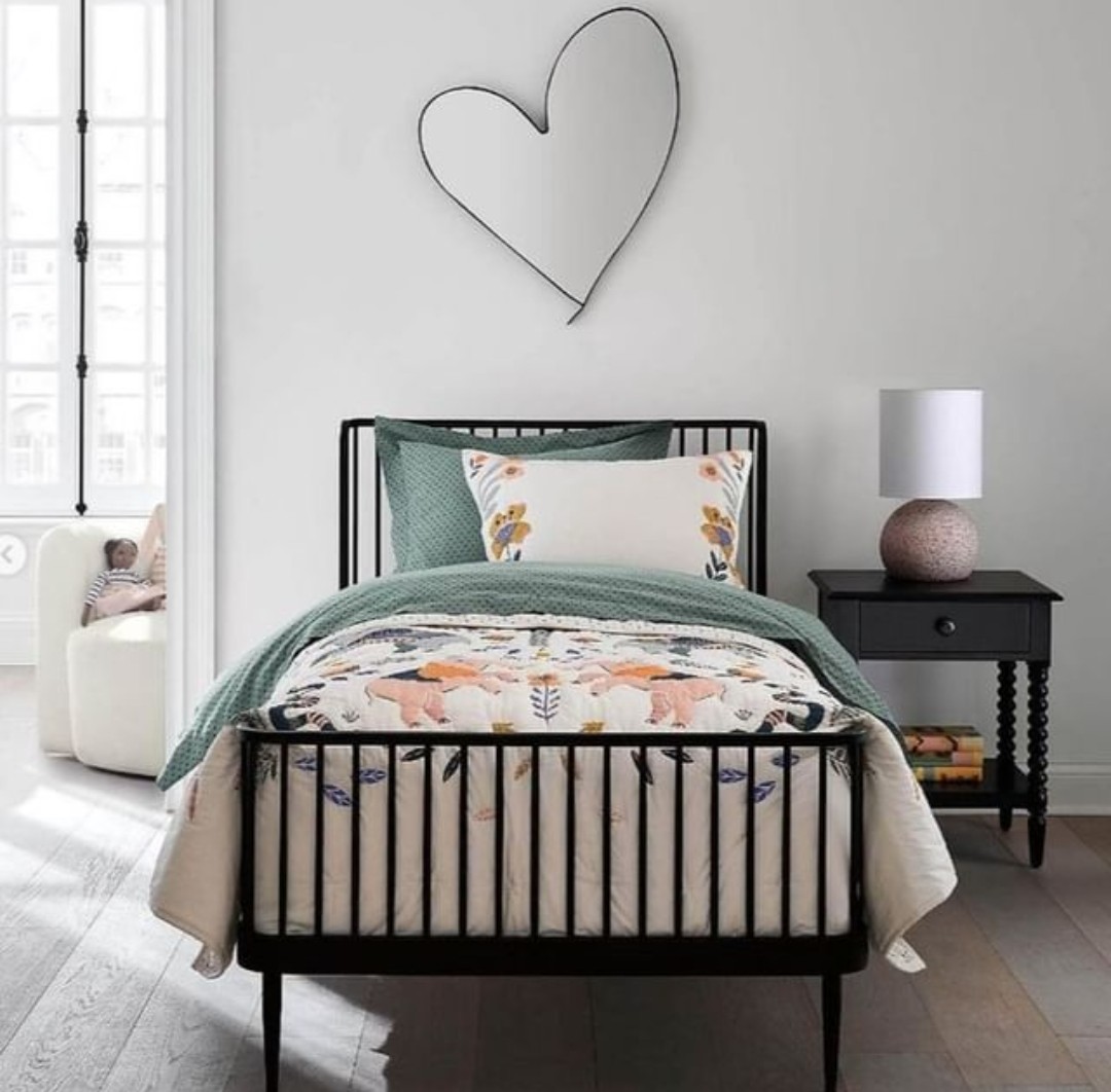 Black bedframe with love heart wall hanging