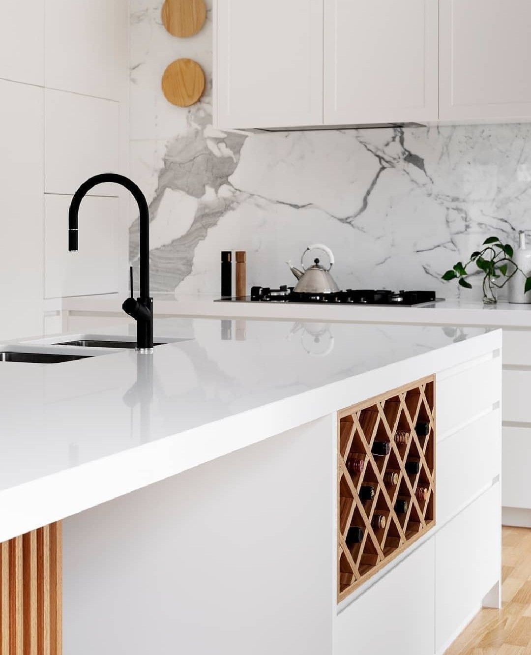 White kitchen with built-in island wine storage