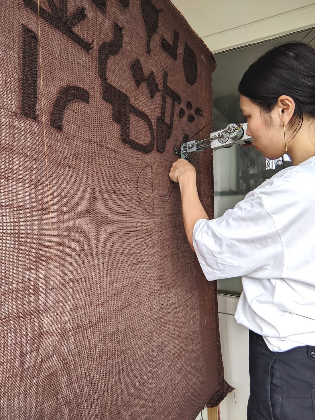 Ayako Matsuo working with tufting gun