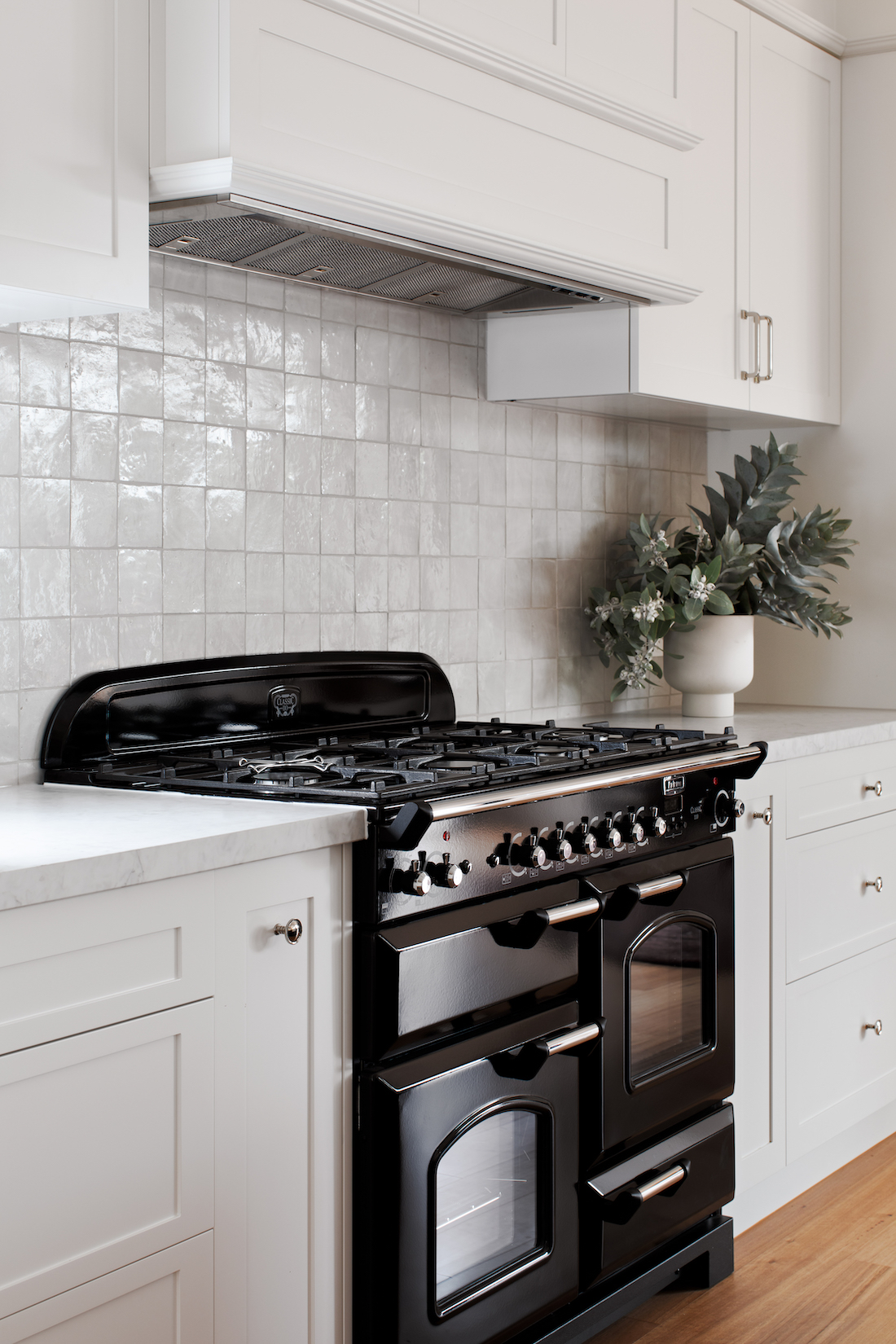 white kitchen bench with black oven