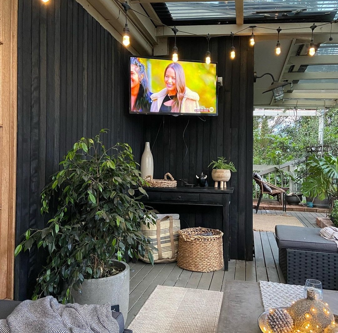 Outdoor deck with tv and seating