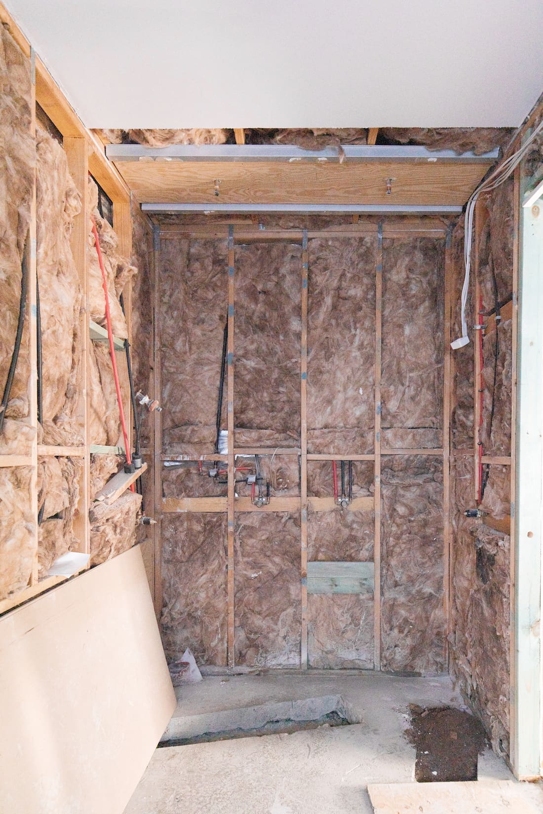 Bathroom renovation part way through process revealing plumbing and electrical 