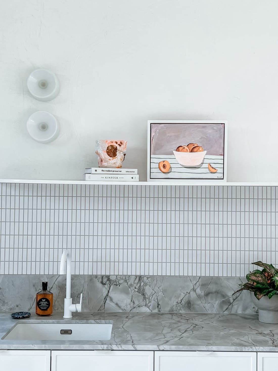 Kitchen with artwork on shelf with peaches