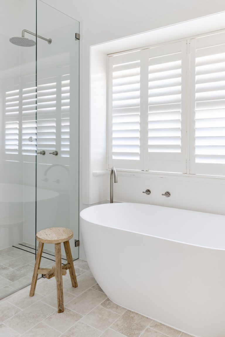 Freestanding bath in white bathroom