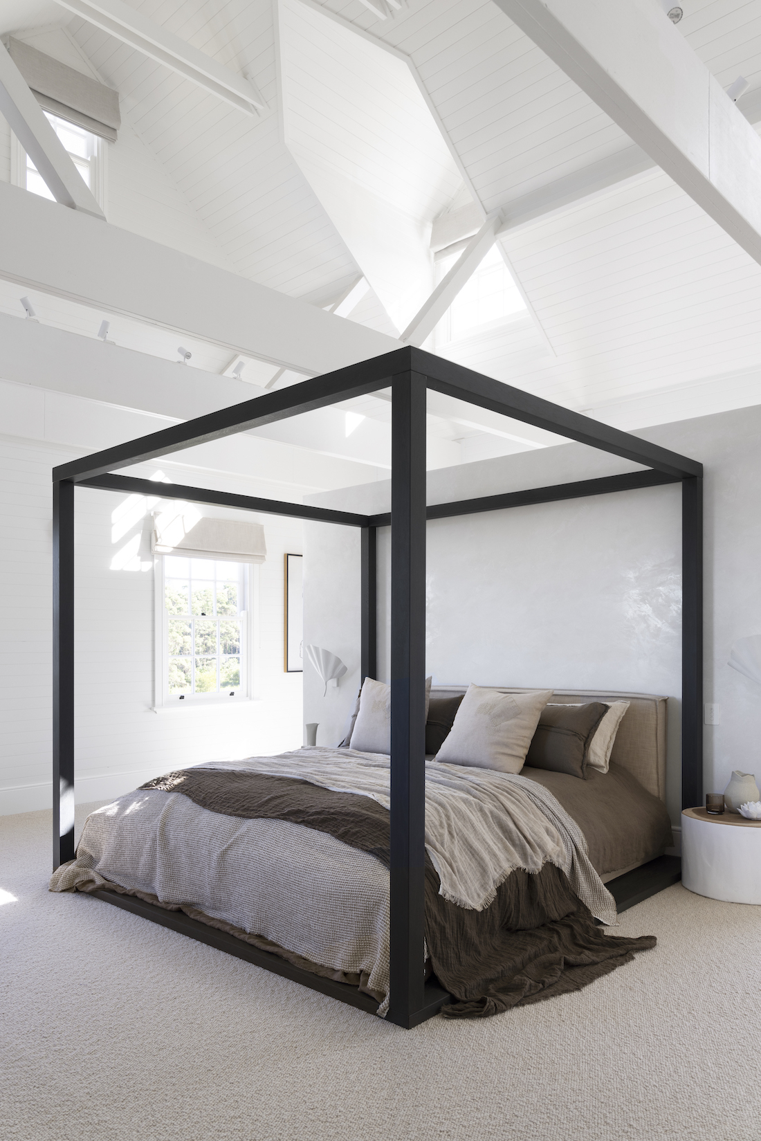 Black framed bed in master bedroom