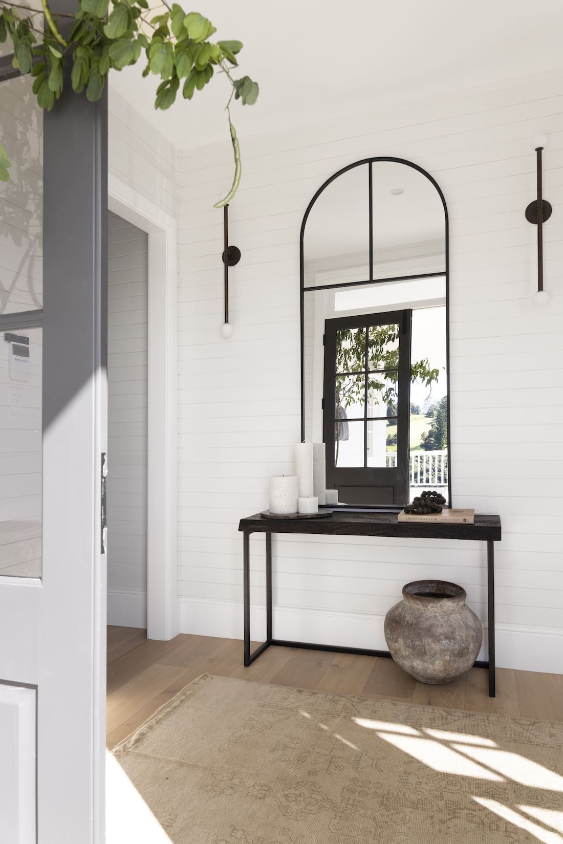 Entry hall table with arch mirror