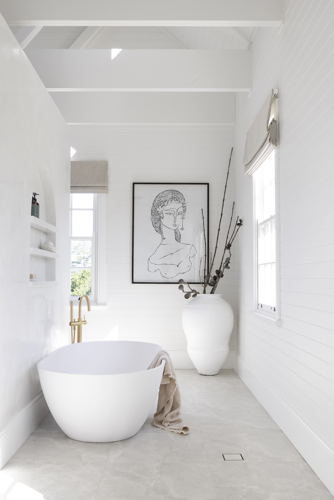 Freestanding tub in white bathroom