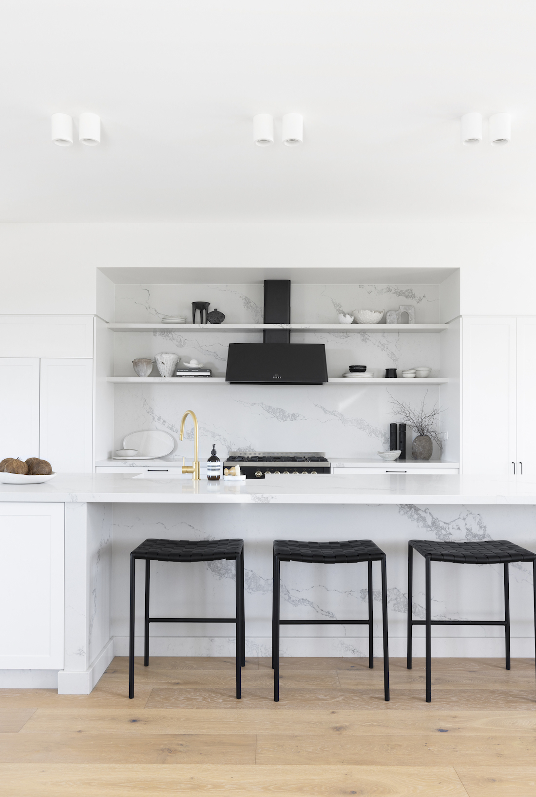 Black bar stools in grey and white kitchen from Studio Haus Co
