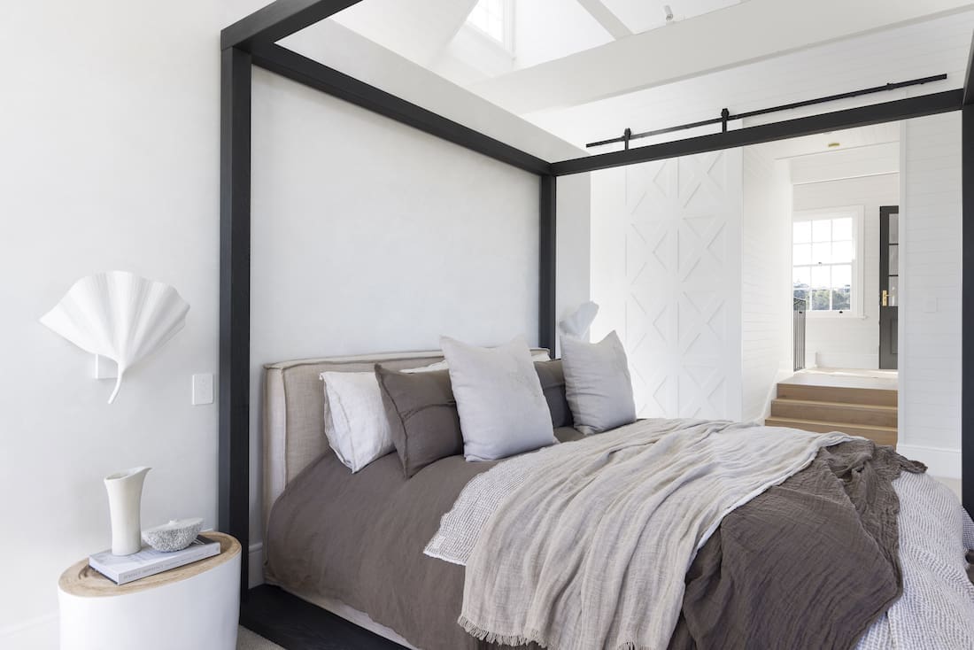 Black framed bed in master bedroom