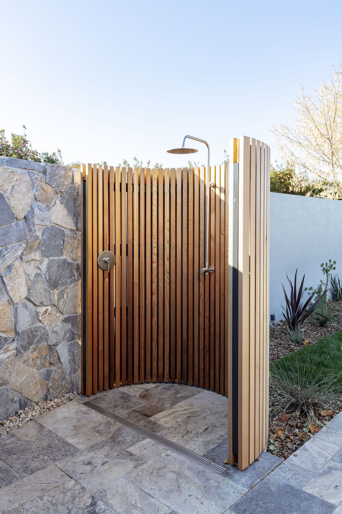 Curved timber wall with outdoor shower inspiration