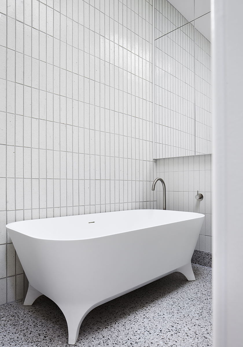 white tile bathroom with tub