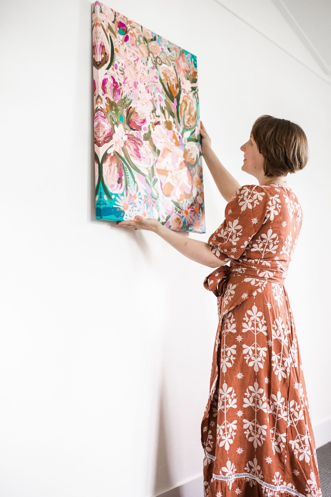 Claire hanging her artwork _ vibrant Australian artworks