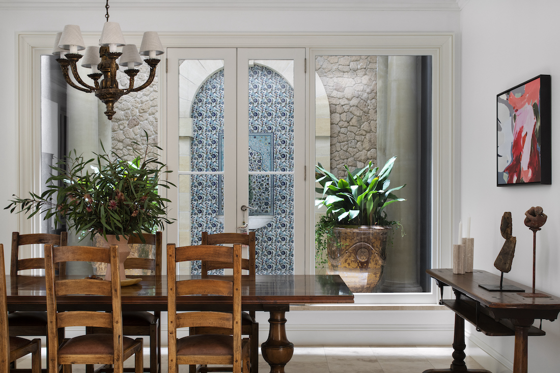 Transcontinental Residence dining room with tiled outdoor feature wall