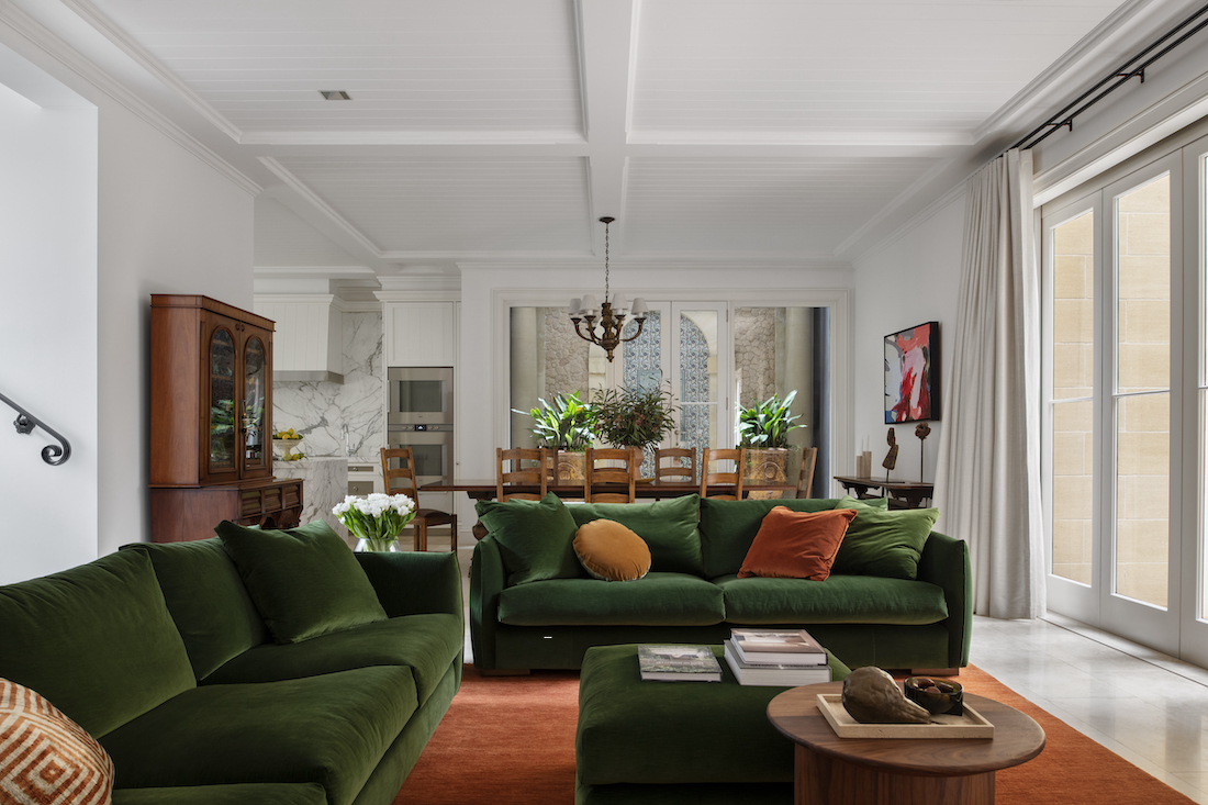 Transcontinental Residence green velvet sofas in living room