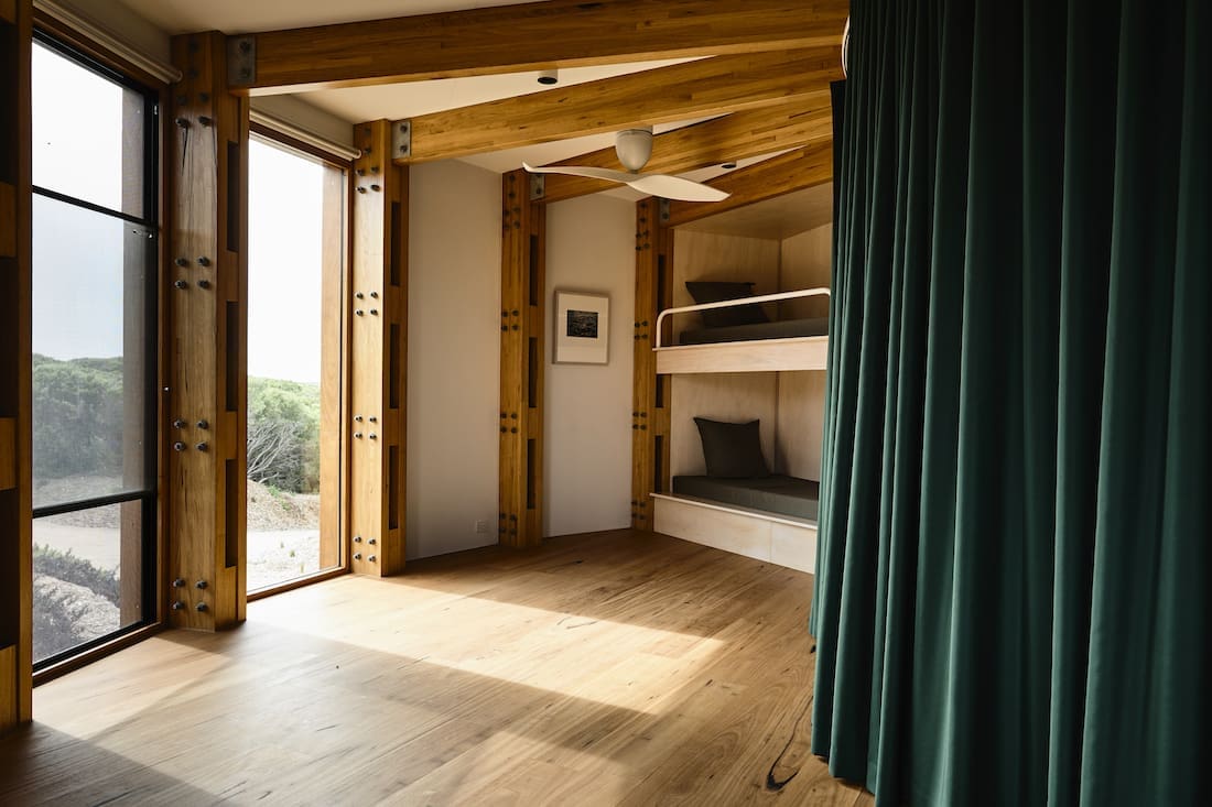 Green curtains separating bunk bed bedrooms