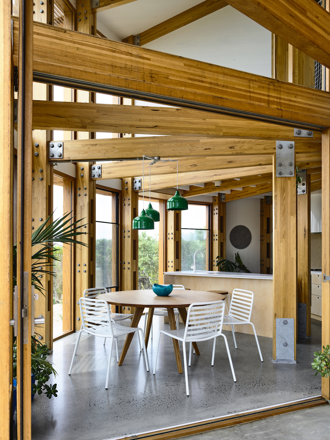 Dining room with exposed beams in round house