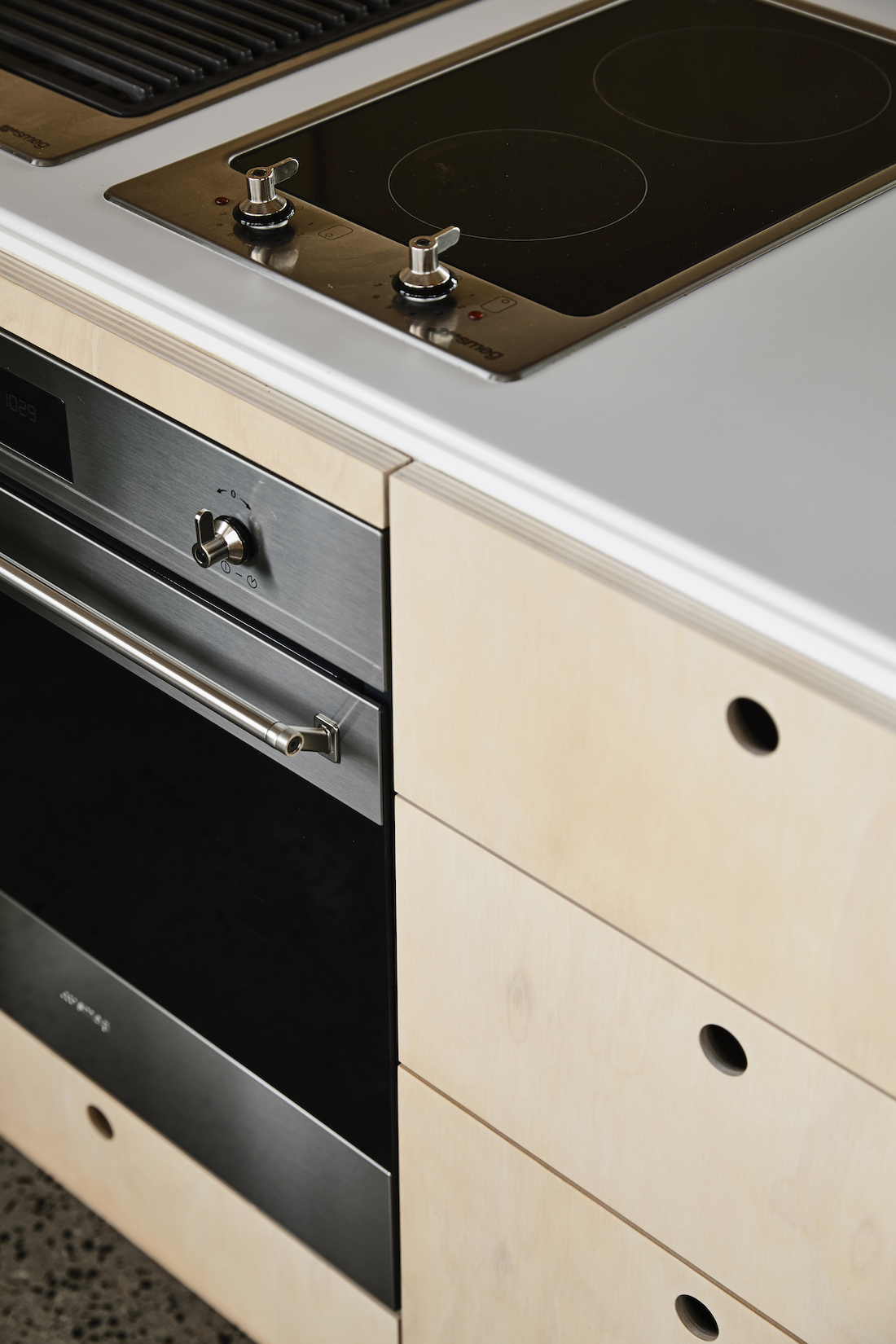 Oven and timber drawers with pull holes in kitchen