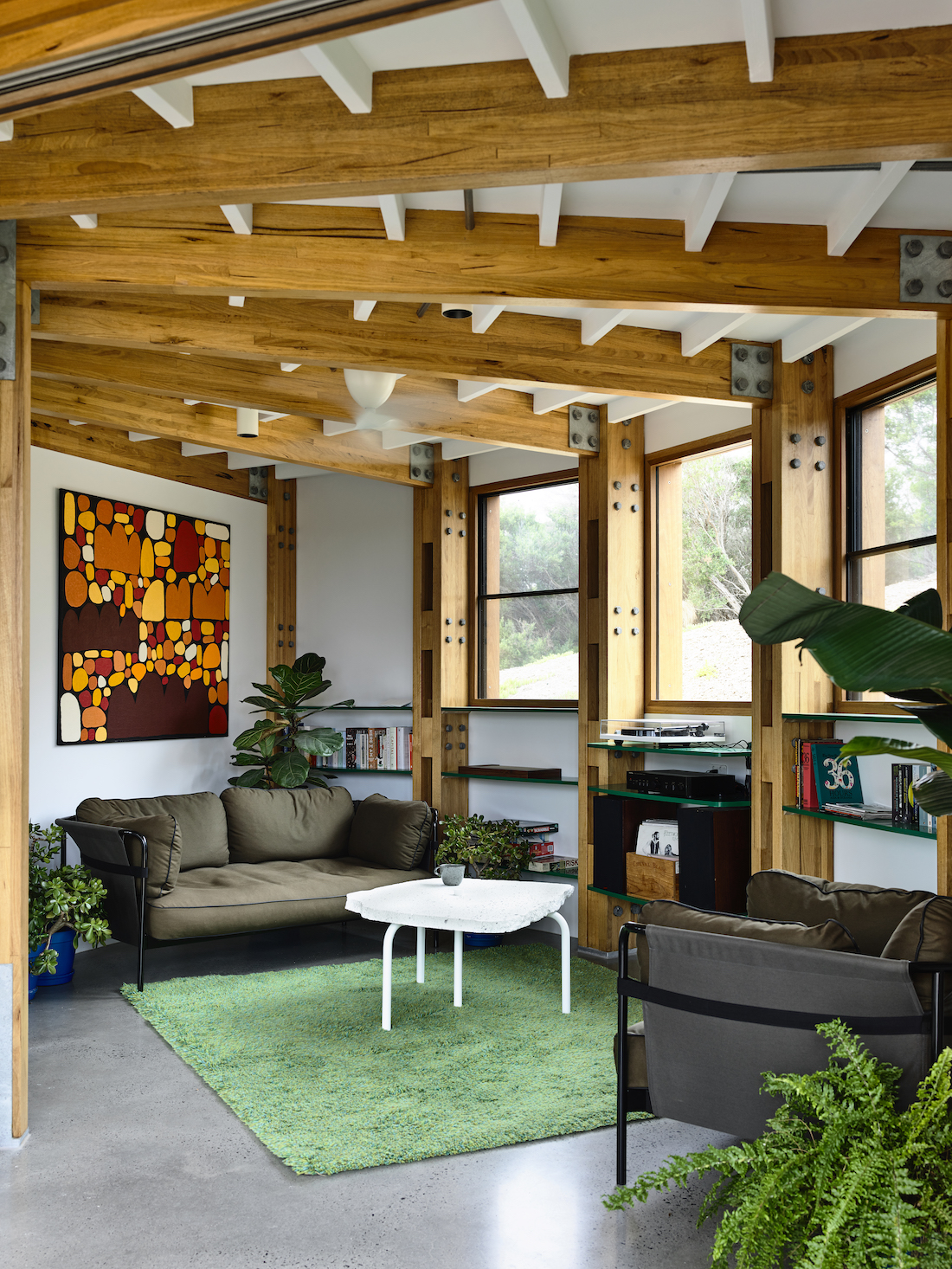 Green floor rug in living room with exposed timber beams