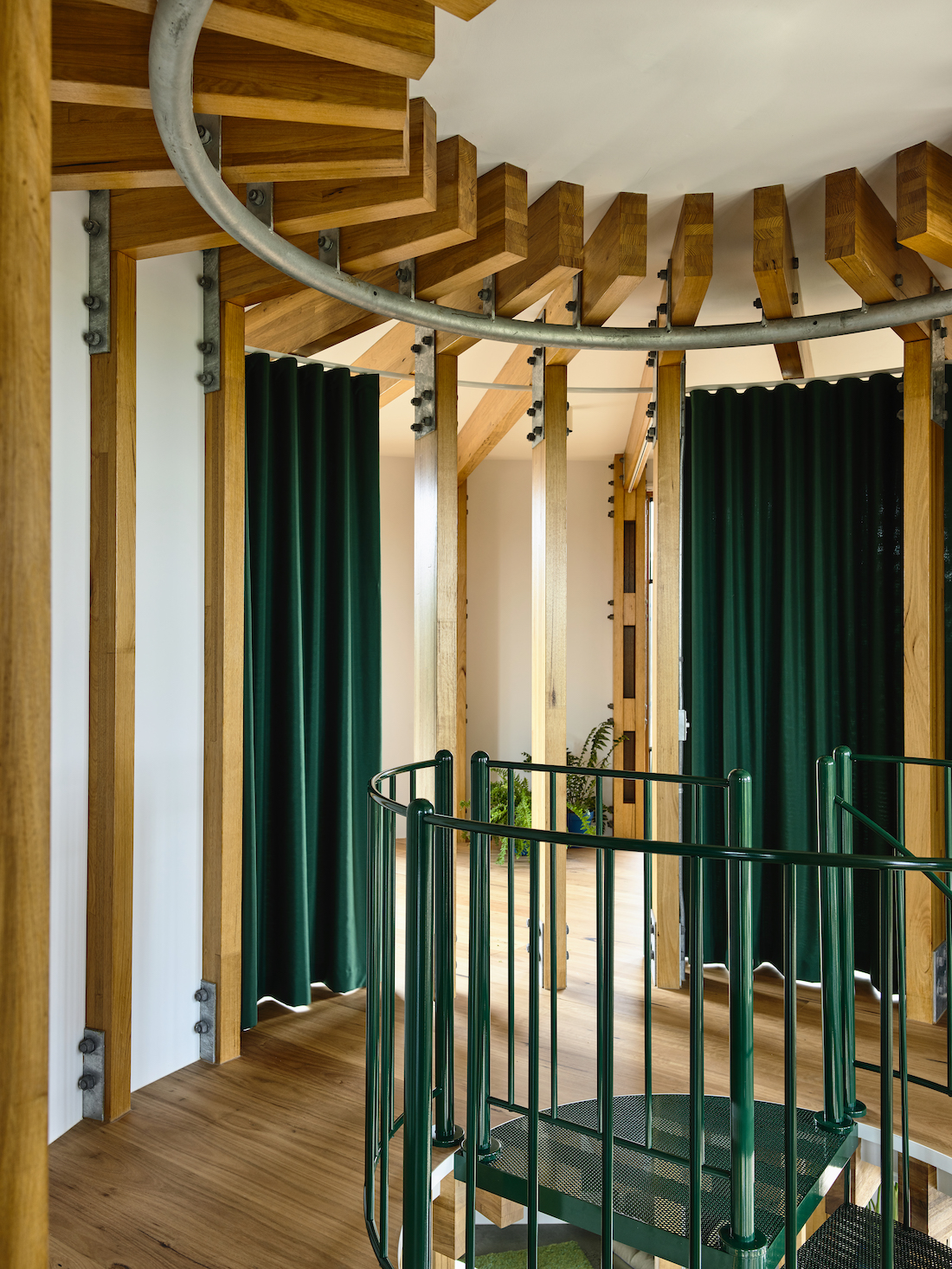 Green metal staircase in round house