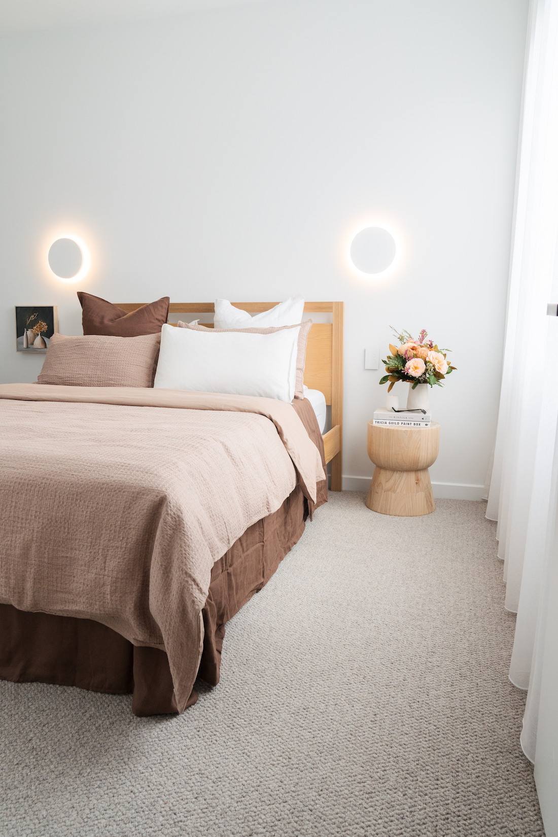 Bedroom with round wall lights