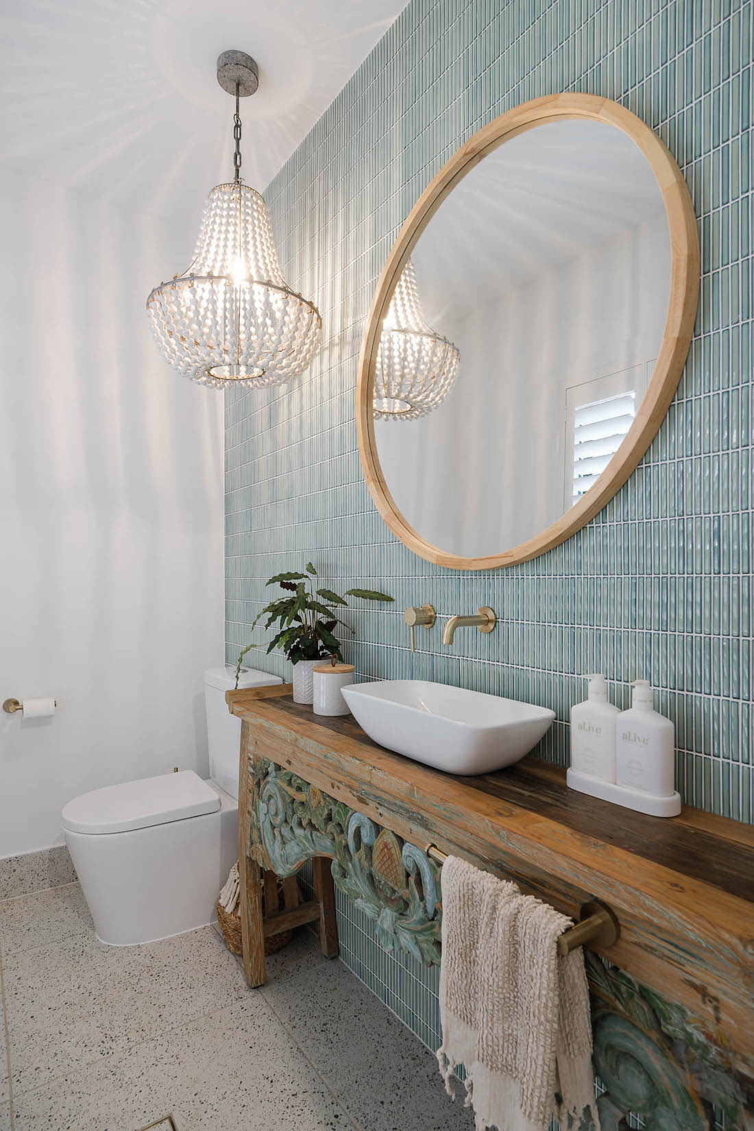 Balinese vanity in bathroom with blue tiled wall