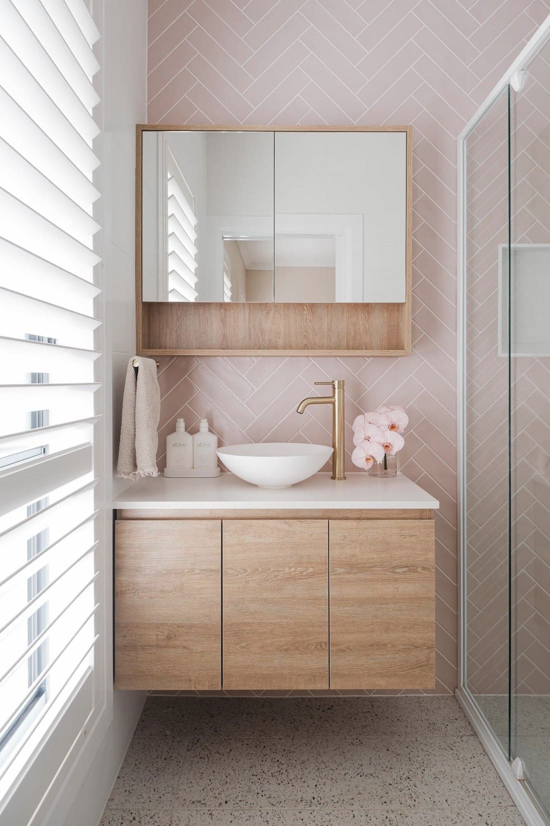 Pink herringbone tile ensuite