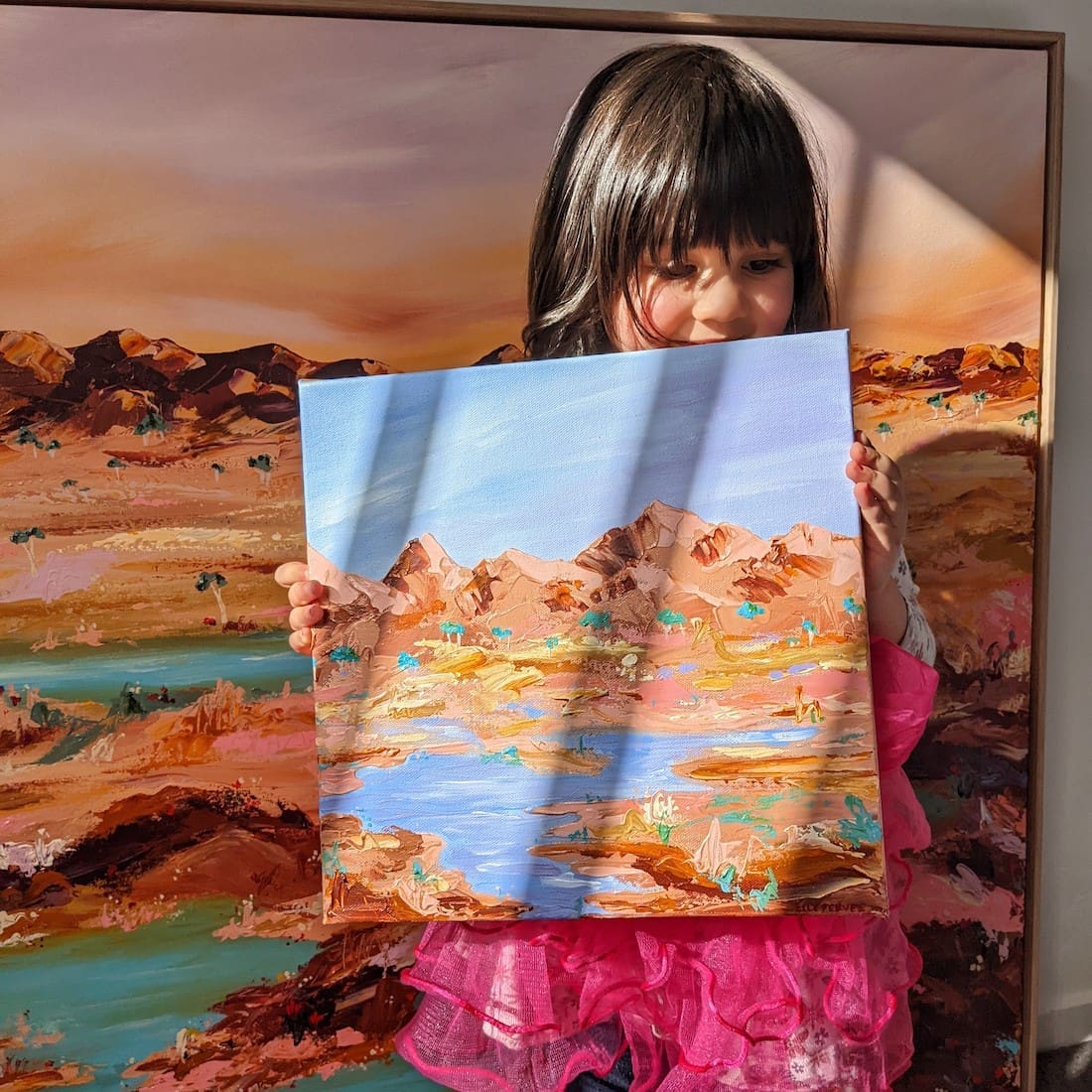 Elle Pervez daughter holding morning light artwork