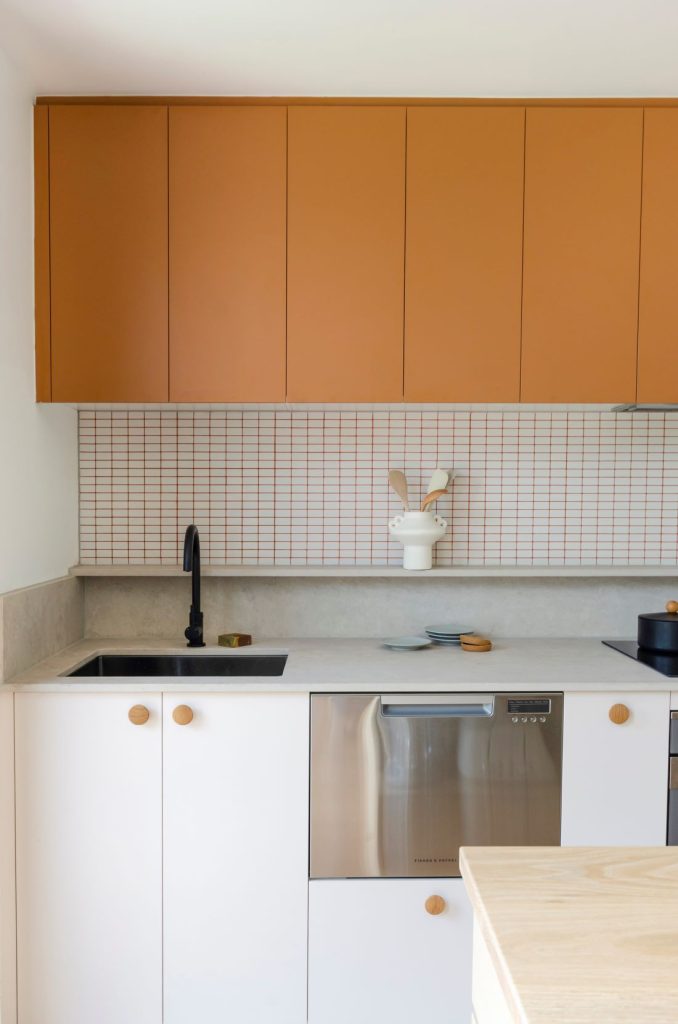 Evergreen: The orange kitchen with coloured joinery and grout