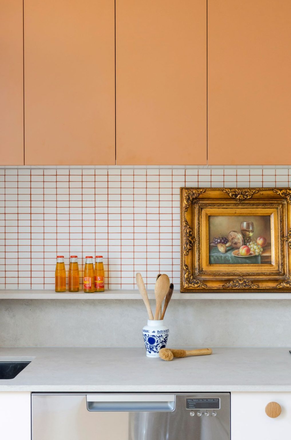 Evergreen: The orange kitchen with coloured joinery and grout