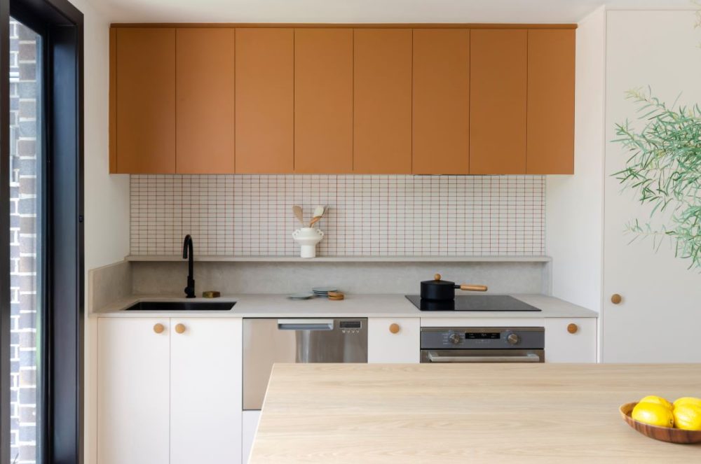 Evergreen: The orange kitchen with coloured joinery and grout