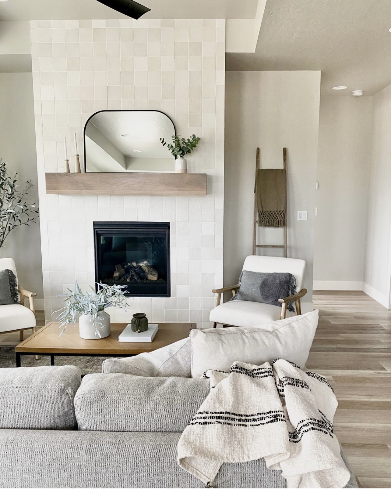 Earthy living room with square tile fireplace