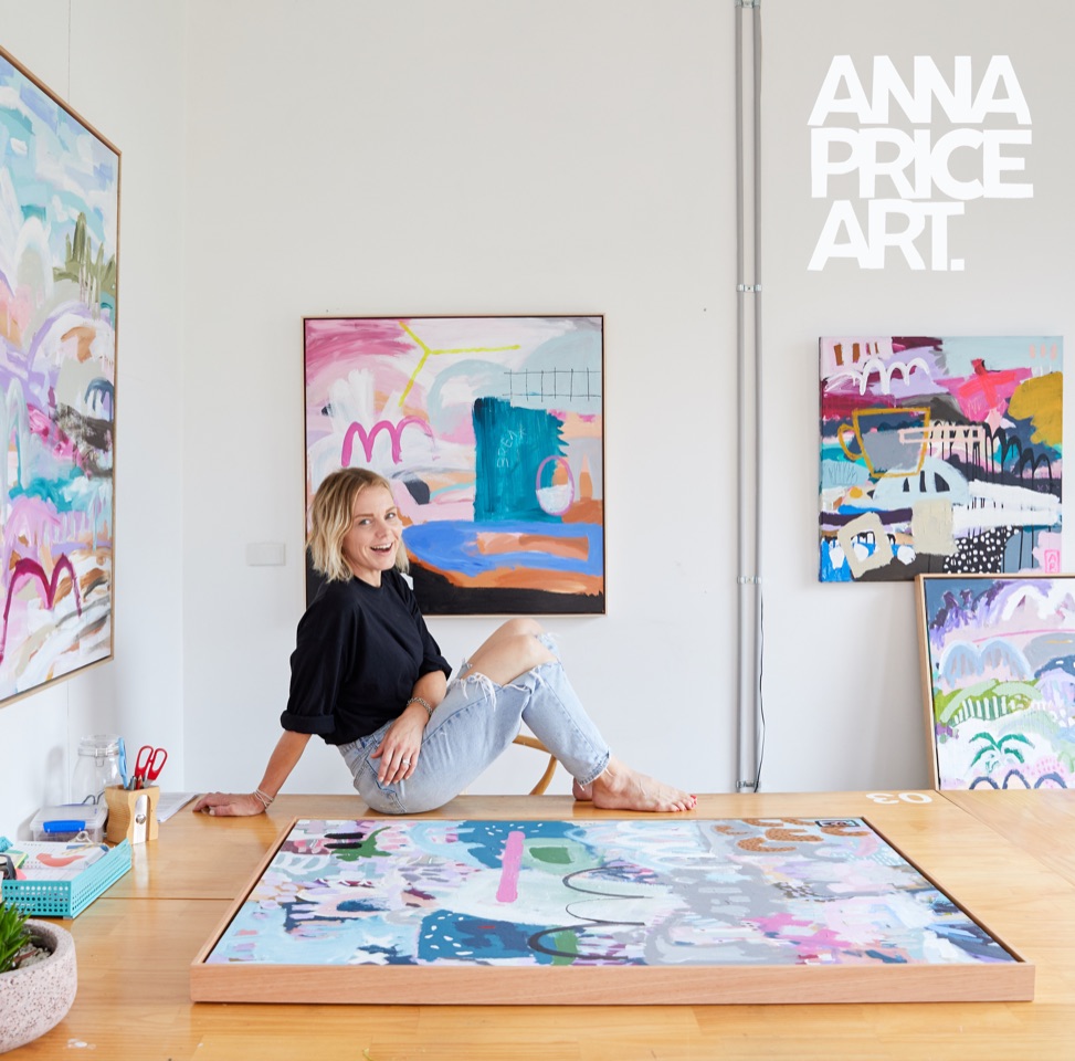 Abstract artist Anna Price in front of of artworks
