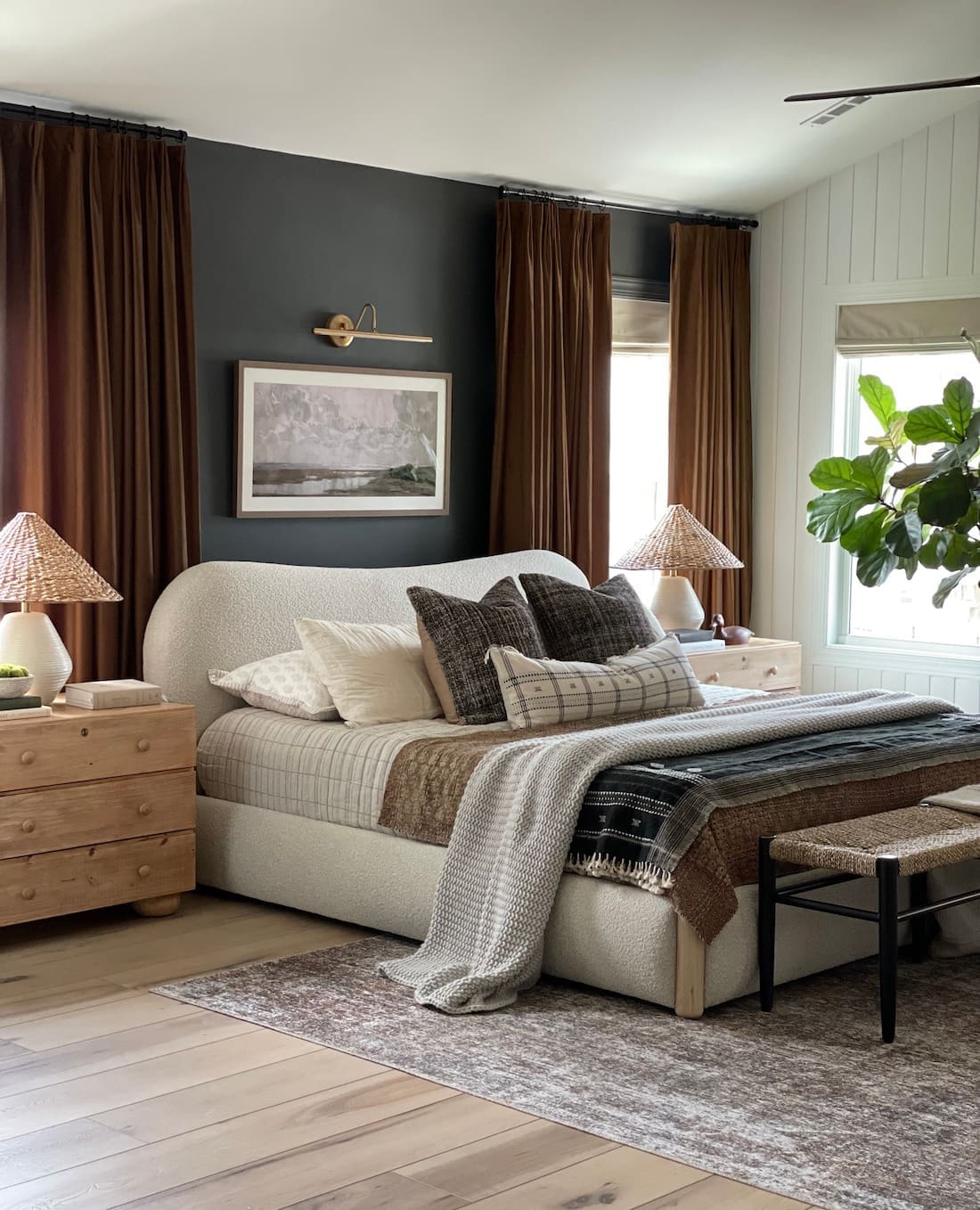 Moody luxe bedroom with dark feature wall