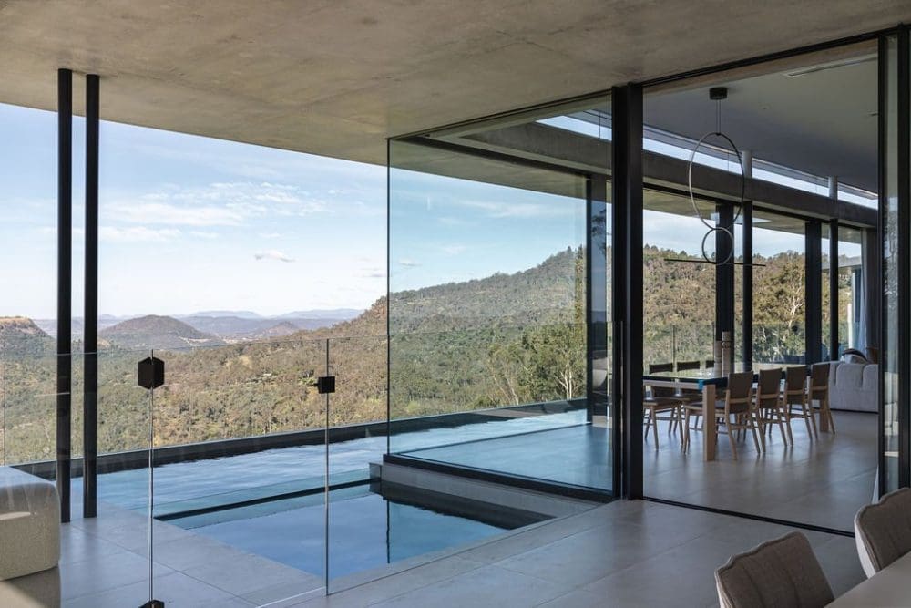 Glass walls around dining room and living room with in built pool