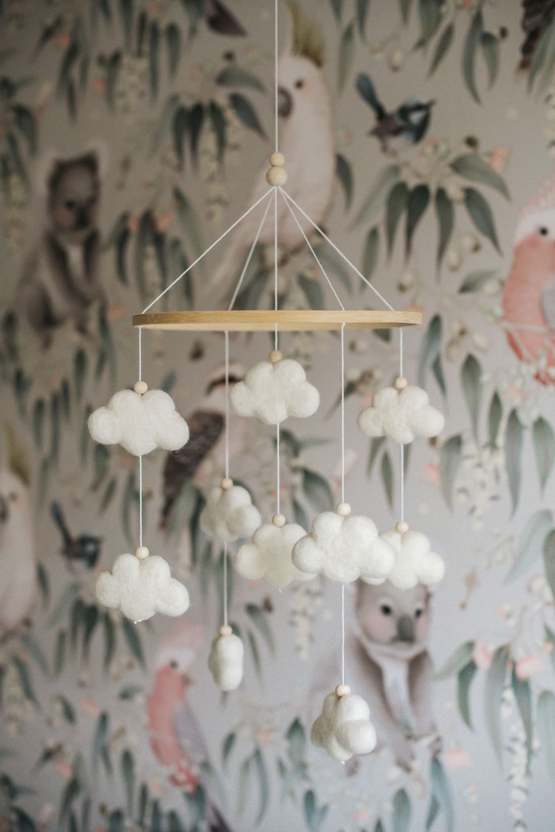 Cloud mobile and Australian animal wallpaper in gender neutral nursery