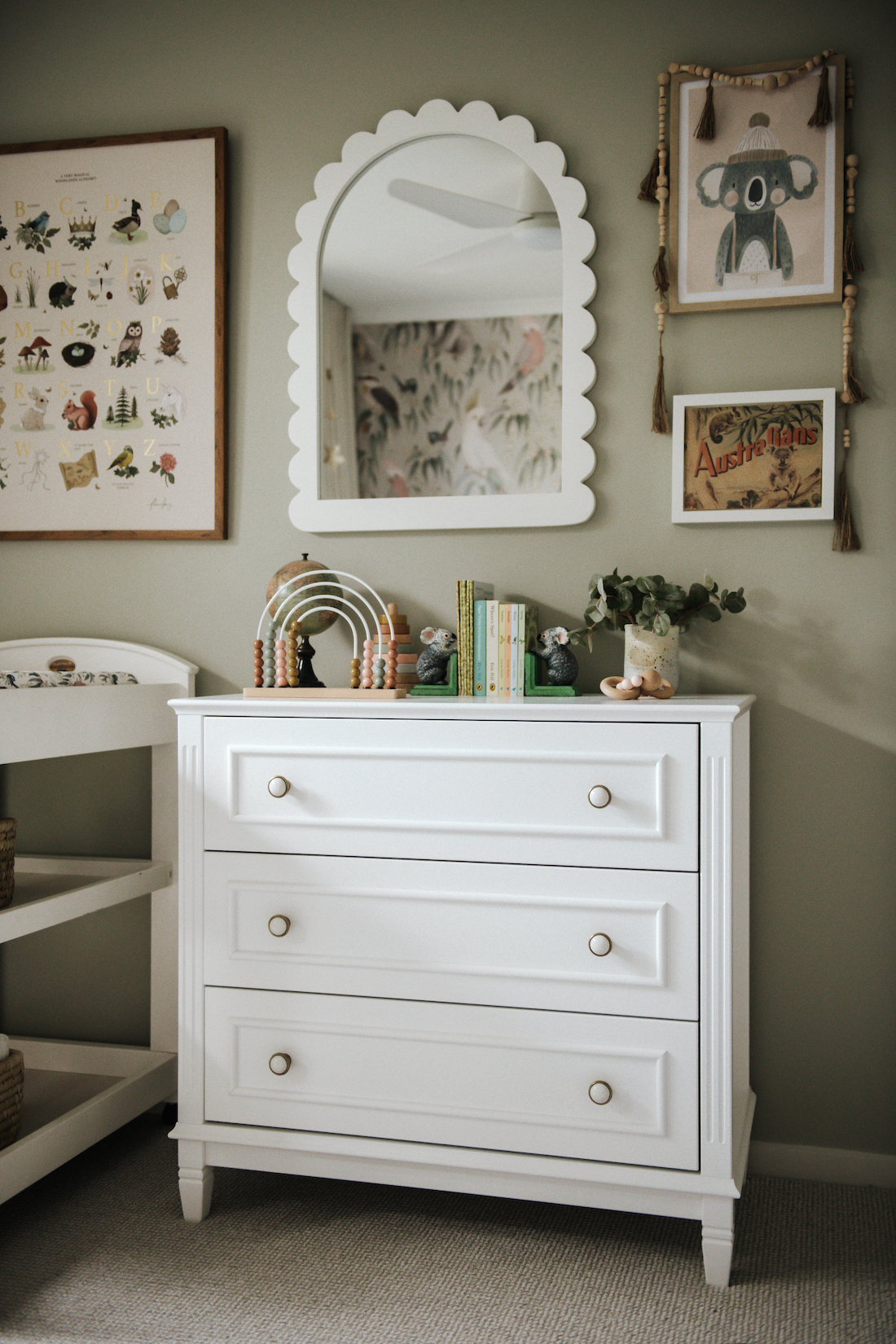 White chest of drawers styled in gender neutral nursery