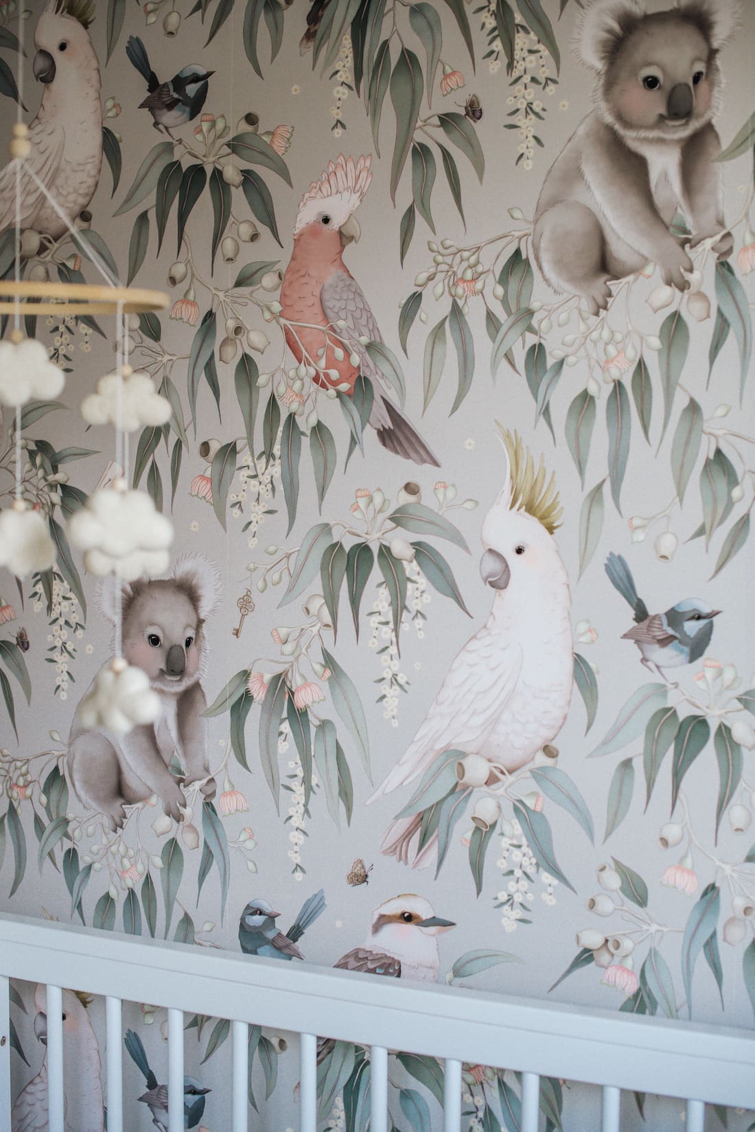 Cloud mobile and Australian animal wallpaper in gender neutral nursery