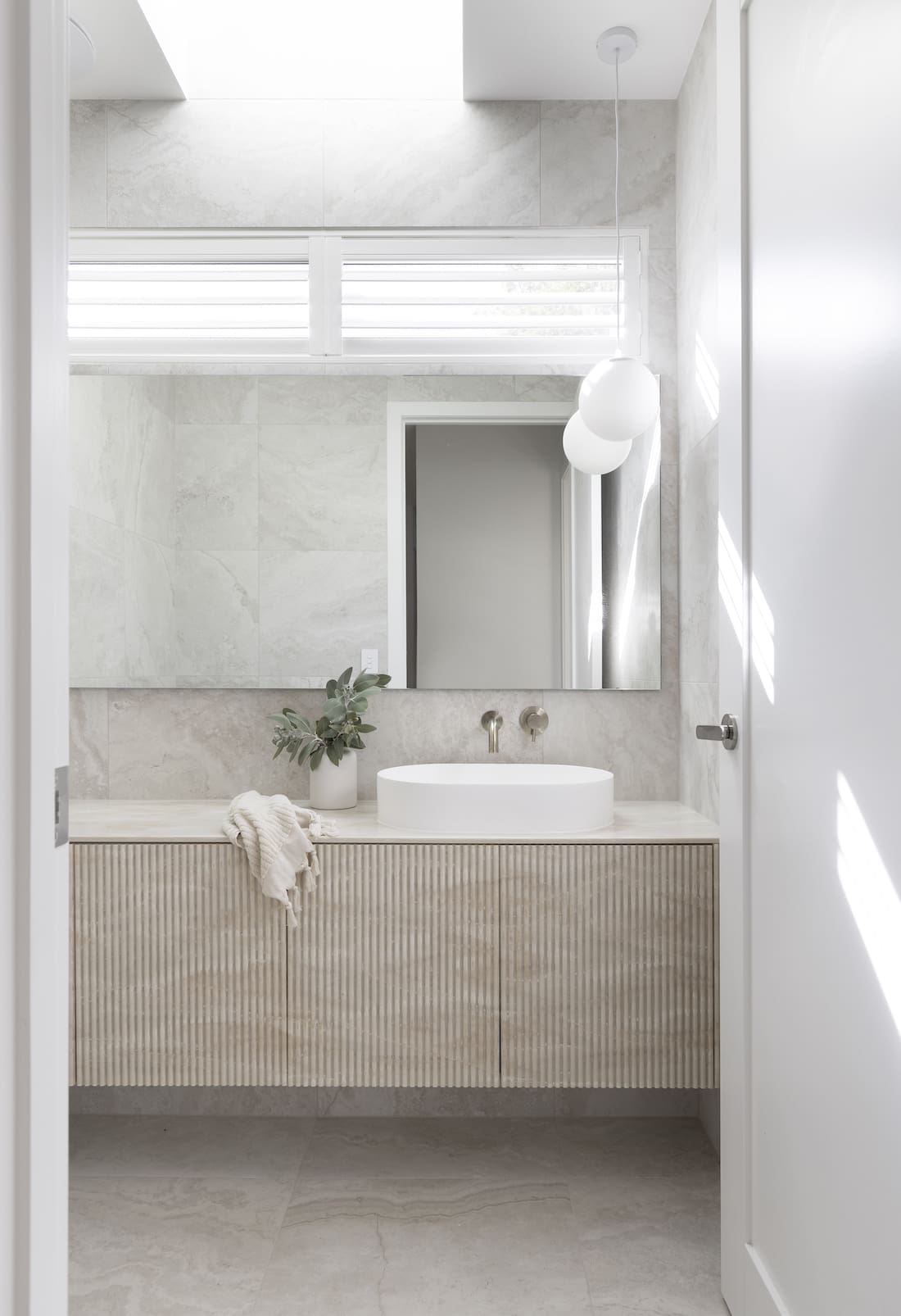 White bathroom with timber cabinetry