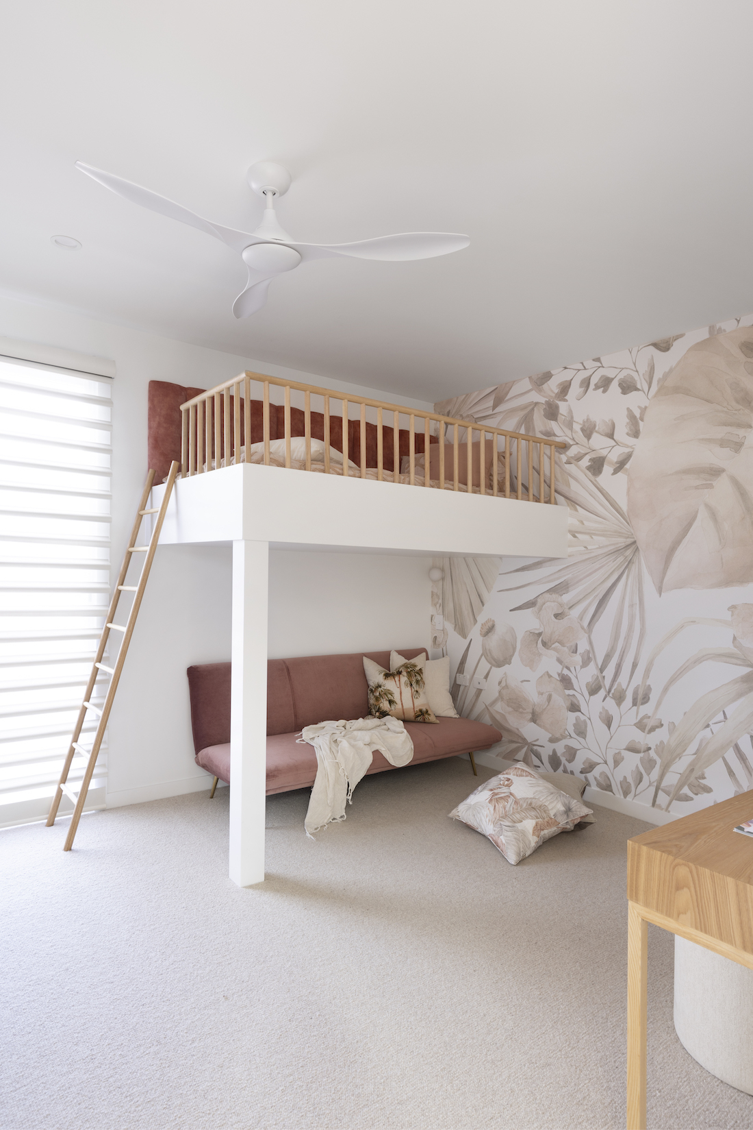 Cool built in bunk bed with ladder and statement wallpaper in girls bedroom