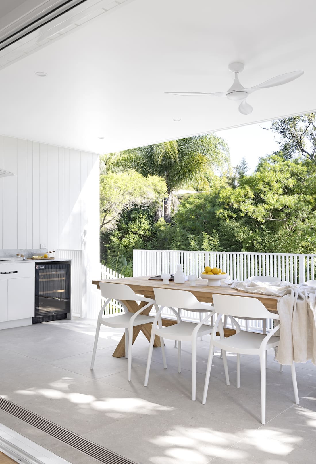 Exterior deck with dining table and outdoor kitchen