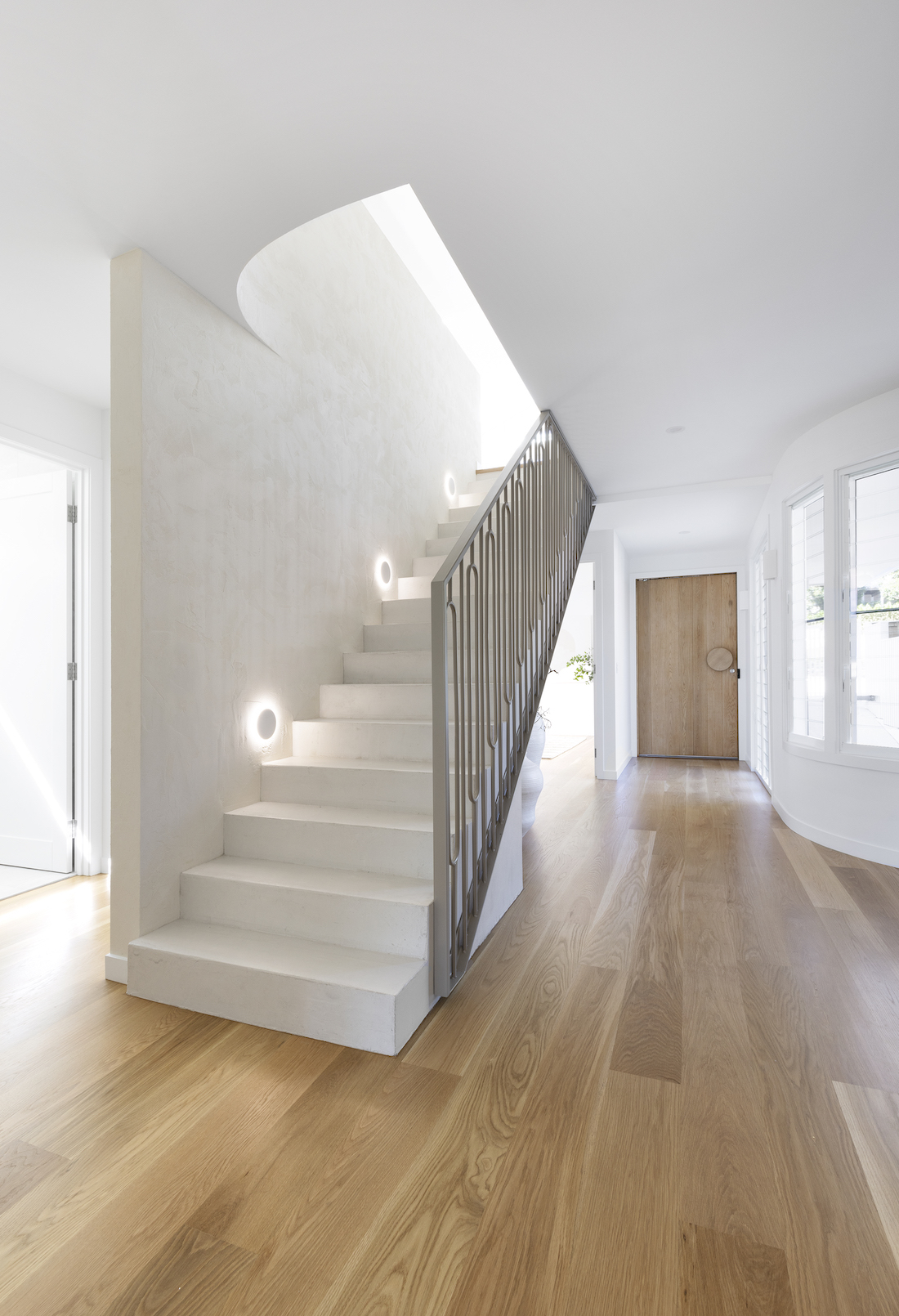 Ornate metal staircase balustrade in home with American oak flooring