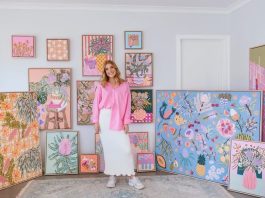 Amy Gibbs with collection of colourful artwork