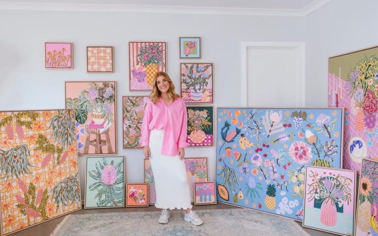 Amy Gibbs with collection of colourful artwork