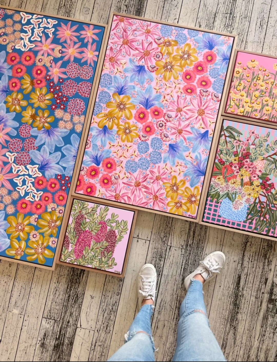 Collection of floral artworks on floor by Amy Gibbs
